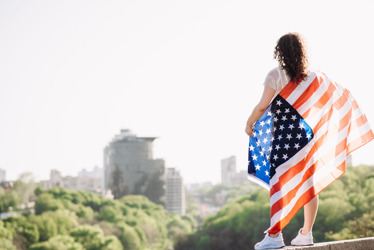 Girl With An American Flag. Independence Day Concept